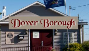 Picture of the Dover Borough building with red, cursive text over top of the building, "Dover Borough"